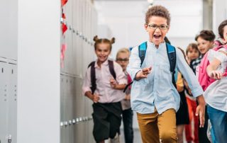 Elementary school kids running down hallway