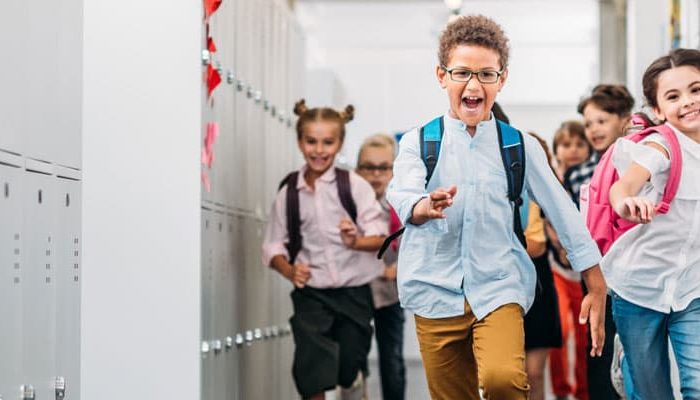 Elementary school kids running down hallway
