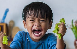 Young child showing signs of anger and stress