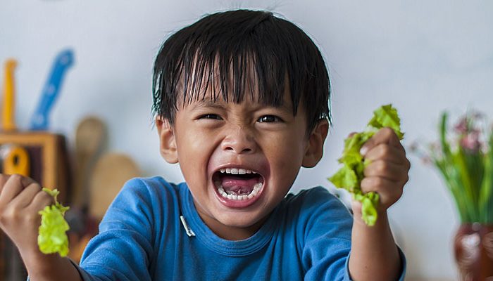 Young child showing signs of anger and stress