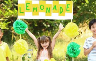 Kids selling drinks at a lemonade stand
