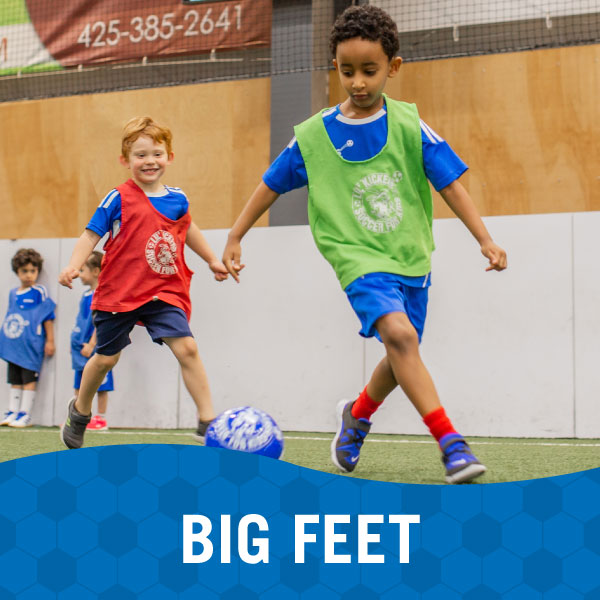 Two children play soccer in Lil' Kickers Big Feet class