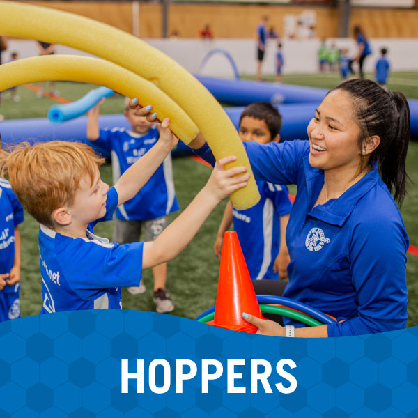 Instructor and children play in Lil' Kickers Hoppers class